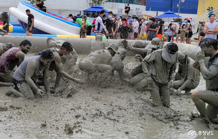 参加保宁海洋泥浆博览会“泥浆比赛”的参赛队选手互相向另一队选手泼泥浆。