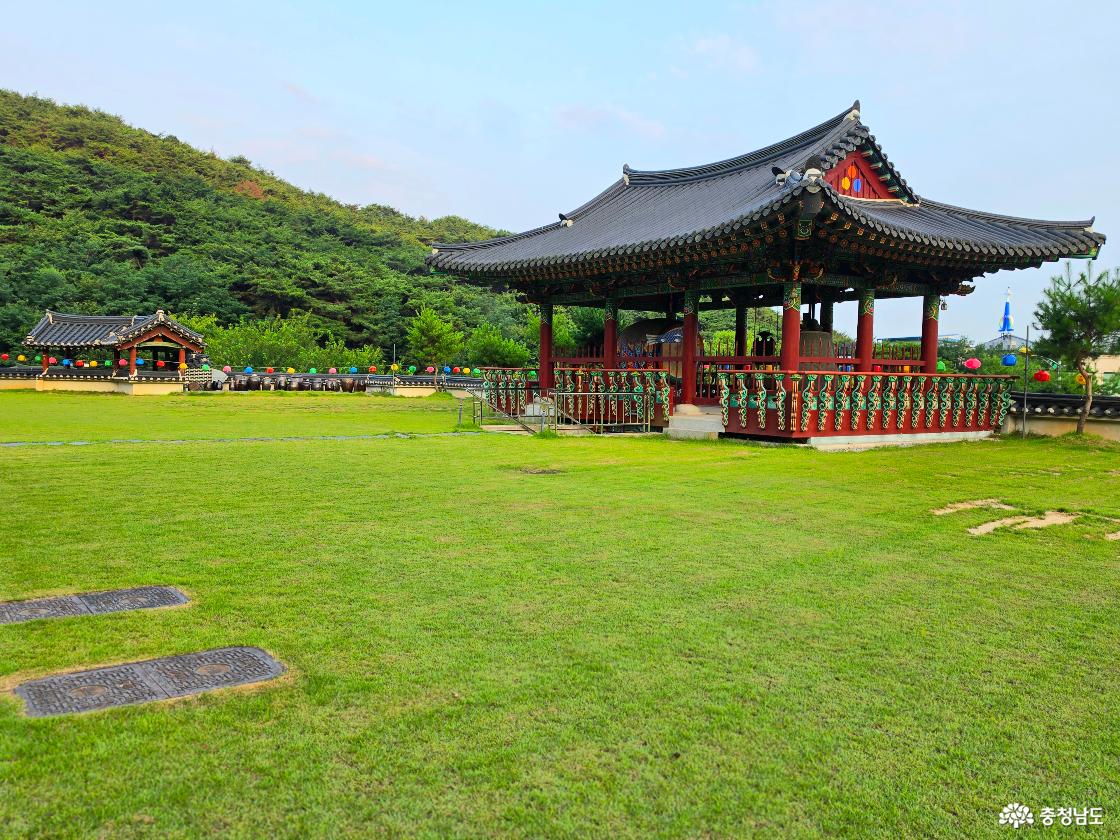 넓은 잔디마당 한가운데 자리한 범종각에는 범종과 법고 등이 함께 놓여 있었다. 알록달록한 연등과 부춘산의 초록 풍경이 어우러져 서광사의 고즈넉한 분위기를 더했다.